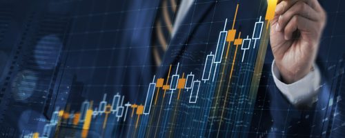 Business growth, progress or success concept. Businessman is drawing a growing virtual hologram stock bar chart on dark blue background.